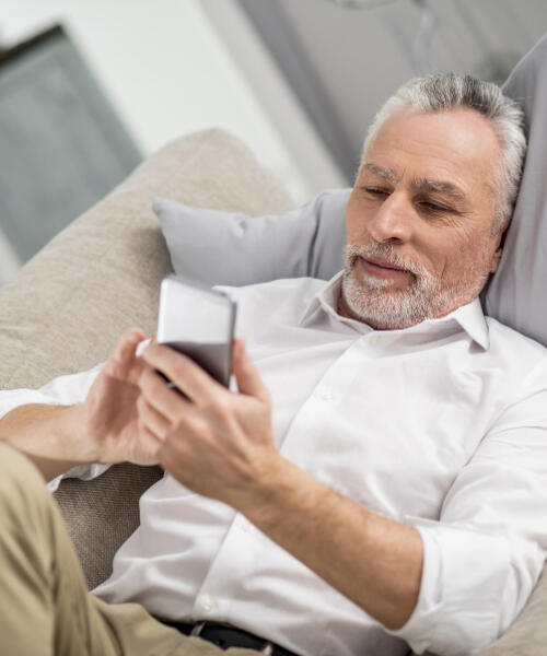 middle-aged man checking his Showing Yourself Grace email on his phone man-showing-himself-grace